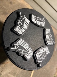 a set of black and white stickers on a black plate
